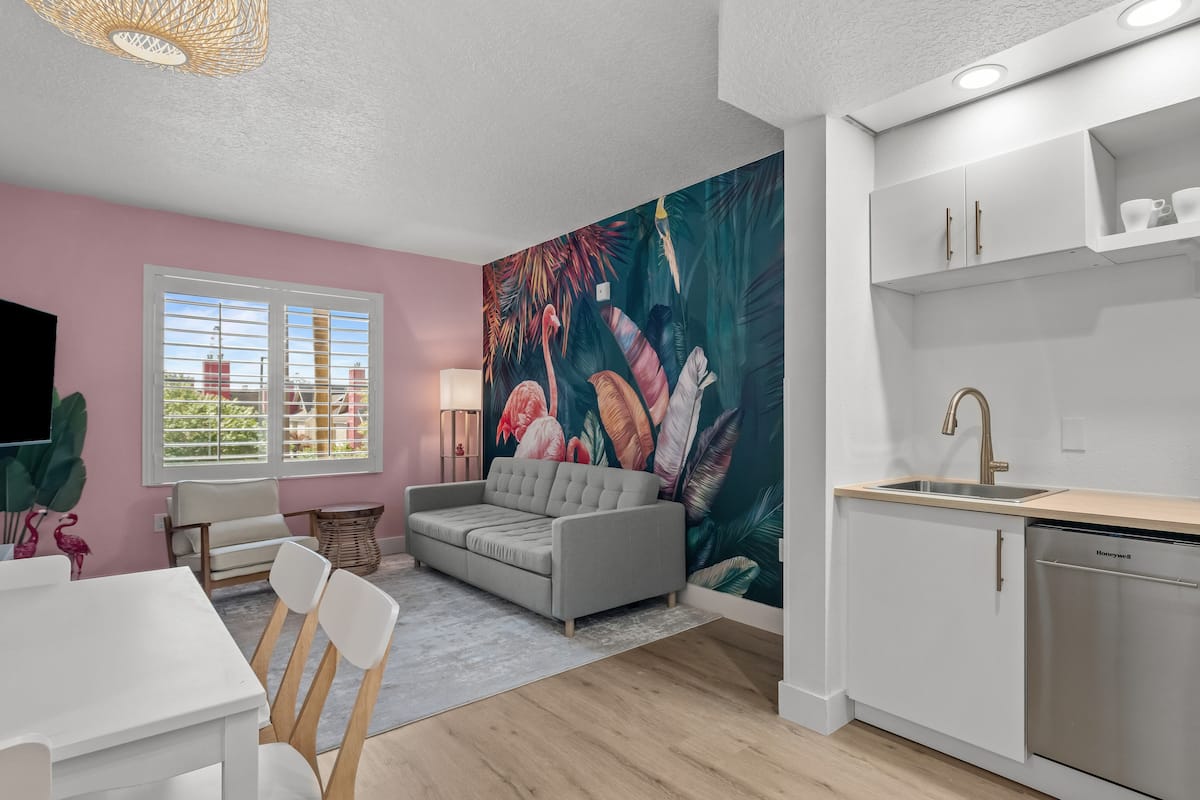 Living room with flamingo wallpaper at Stay Sky Suites, Orlando