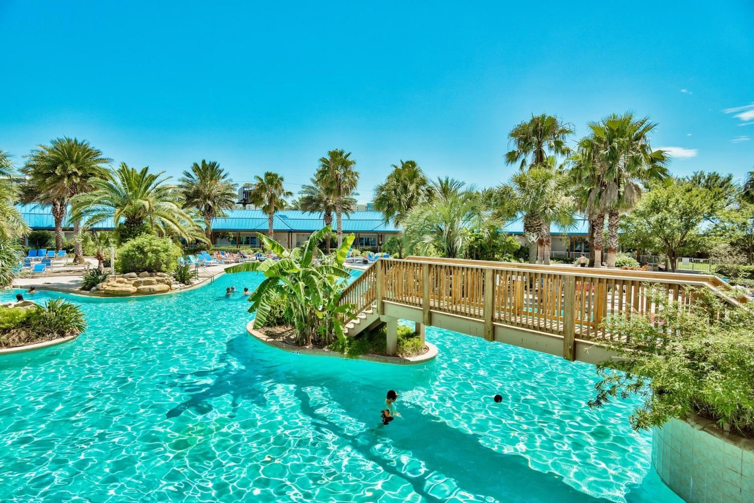 Lagoon pool surrounded by palm trees at The Palms of Destin