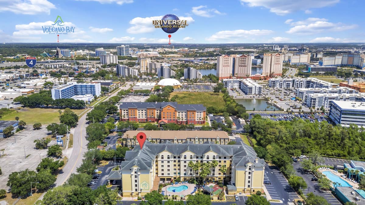 Aerial view of Stay Sky Suites with Universal Orlando and Volcano Bay in the background