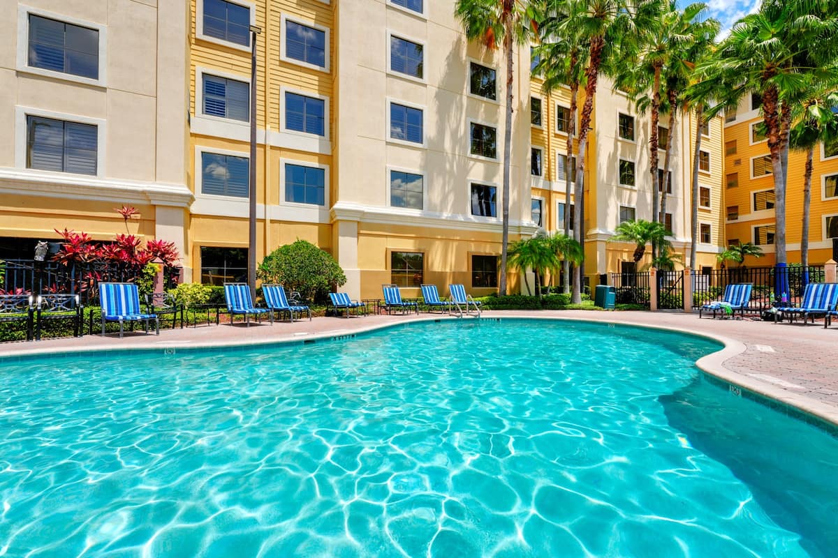 Outdoor pool with lounge chairs at Stay Sky Suites